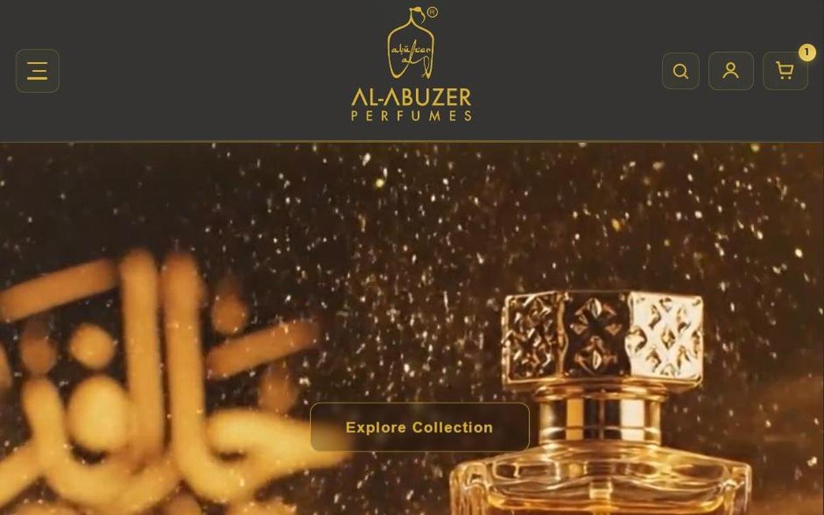 Al-Abuzer Perfumes homepage: a gold-lit perfume bottle over Arabic calligraphy, with an Explore Collection button.